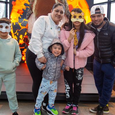 Family with preschool age child in front of Lego dinosaur at OMSI